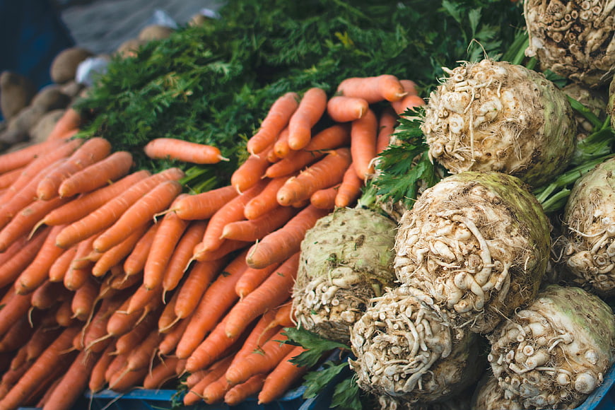 Fresh carrots and celery root at farmers market