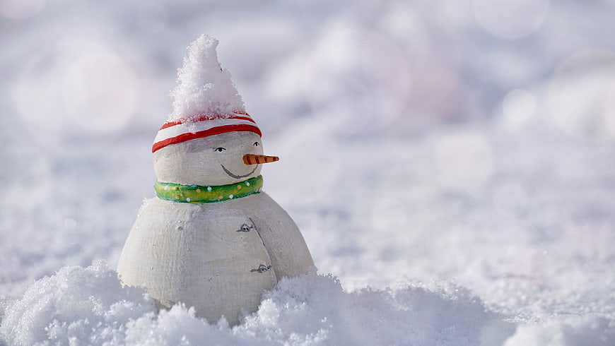 Cute Wooden Snowman Figurine in Snow