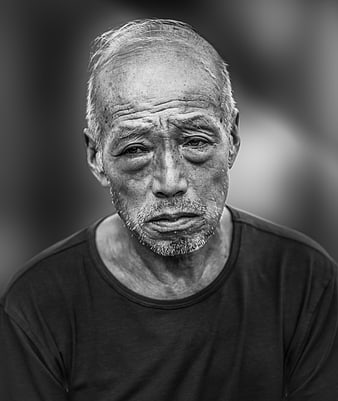 Black and White Portrait of Elderly Man with Melancholic Expression