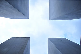 Low angle view of concrete pillars against blue sky