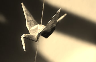 Sepia Origami Crane Hanging in Soft Light