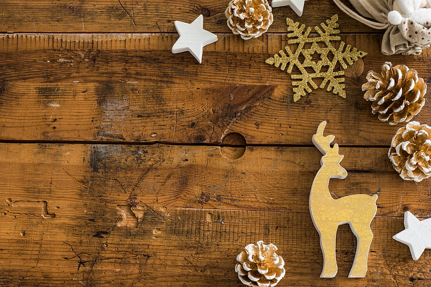 Rustic Christmas Background With Gold Reindeer, Stars, And Pinecones