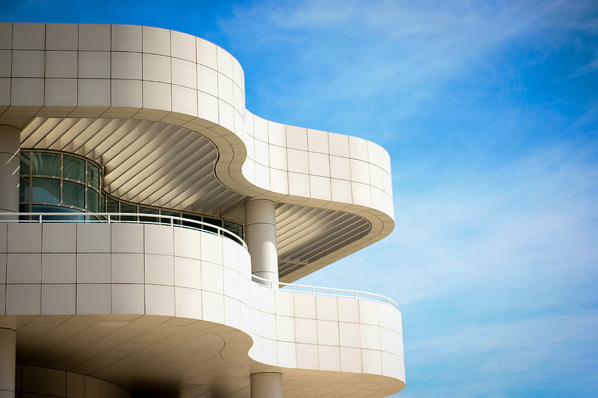 Modern curved white architecture against blue sky