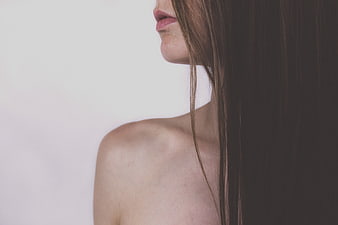 Close-up profile of woman's lips, shoulder, and hair