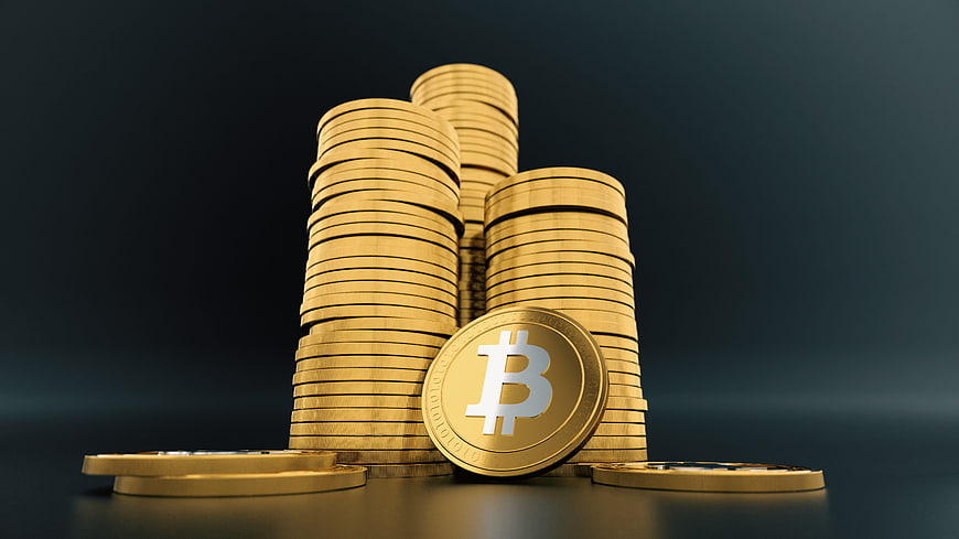 Stacks of Gold Bitcoin Coins on Dark Background