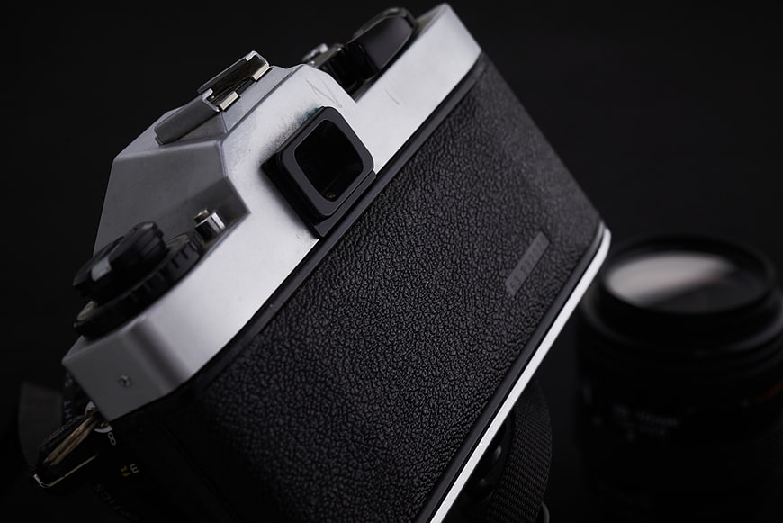 Close-up of vintage film camera on black background