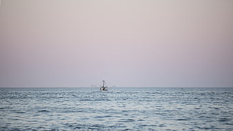 Lone Fishing Boat on Calm Ocean Horizon