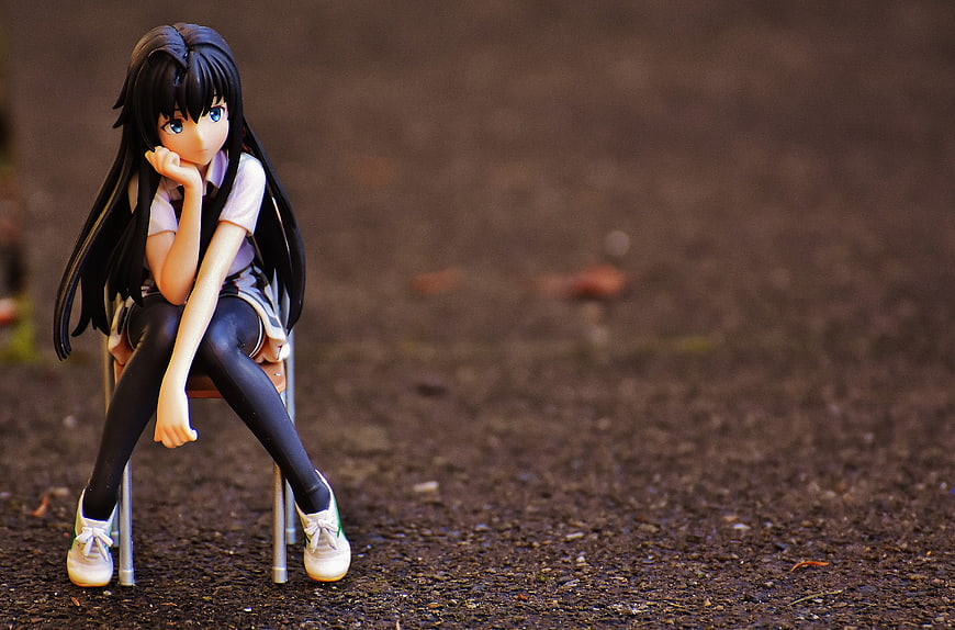 Anime Figure of Girl Sitting on Chair with Thoughtful Pose