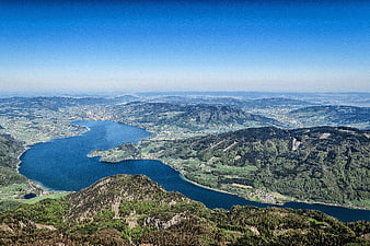 Aerial view of blue lake surrounded by green mountains