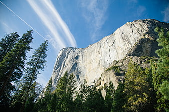 Majestic granite mountain peak rising above pine forest