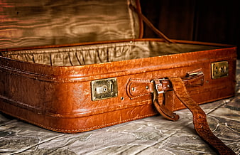 Vintage Brown Leather Suitcase Open on Bed