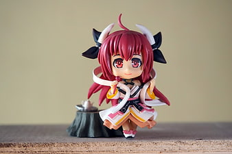 Chibi Anime Figurine With Red Hair And Horns On Wooden Surface