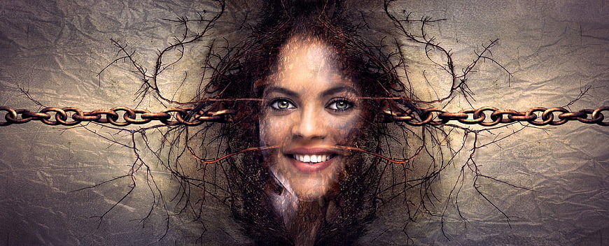 Surreal woman's face emerging from cracked wall with chains