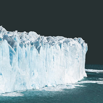 Massive Blue Glacier Face Against Dark Sky