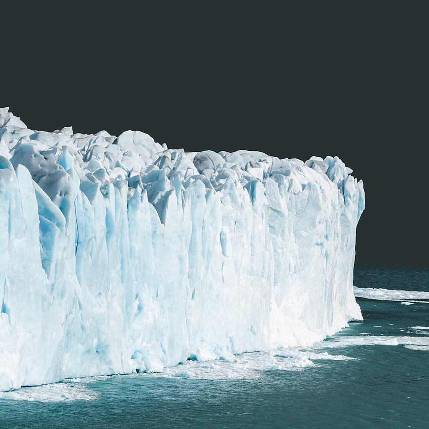 Massive Blue Glacier Face Against Dark Sky
