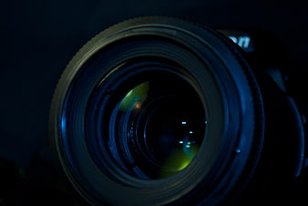 Close-up of DSLR Camera Lens with Blue and Green Reflections