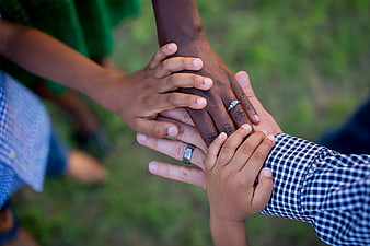 Diverse family hands stacked together in unity and support