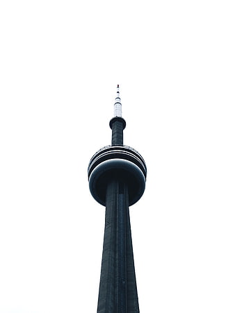 Low angle view of tall concrete tower against white sky