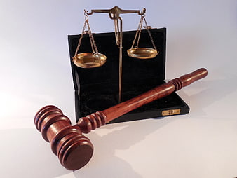 Wooden Gavel and Brass Scales of Justice on White Background