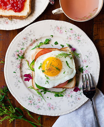 Overhead view of fried egg sandwich on vintage floral plate