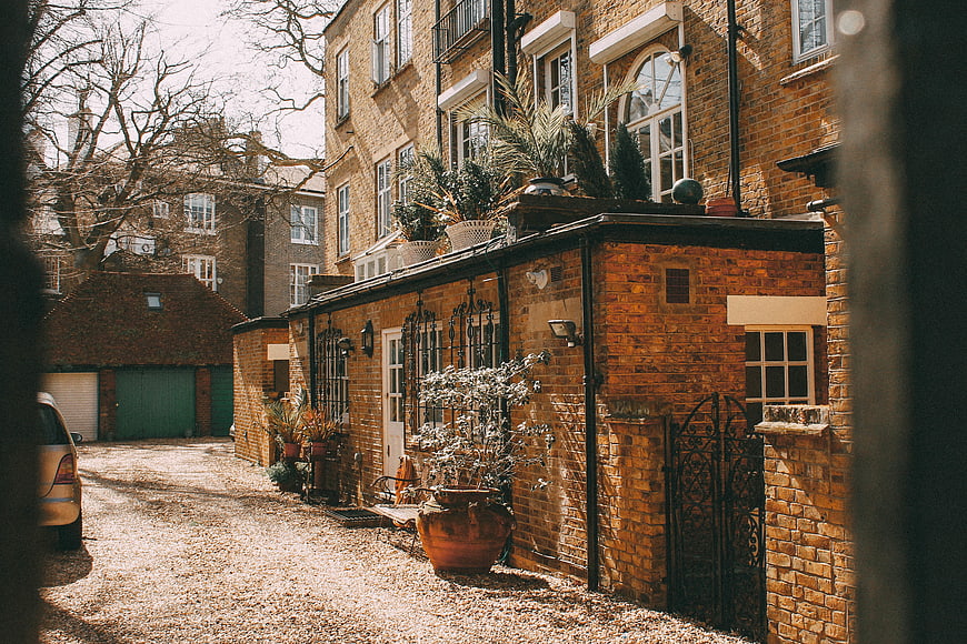 Sunny London Brick Townhouse Backyard with Potted Plants