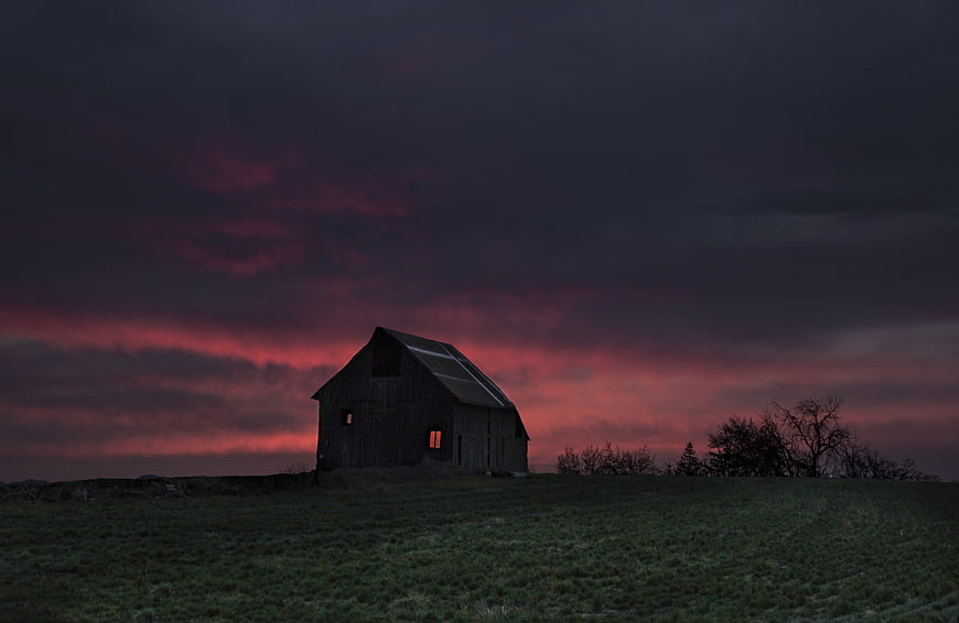 Old Barn Silhouette Against Dramatic Red Sunset Sky