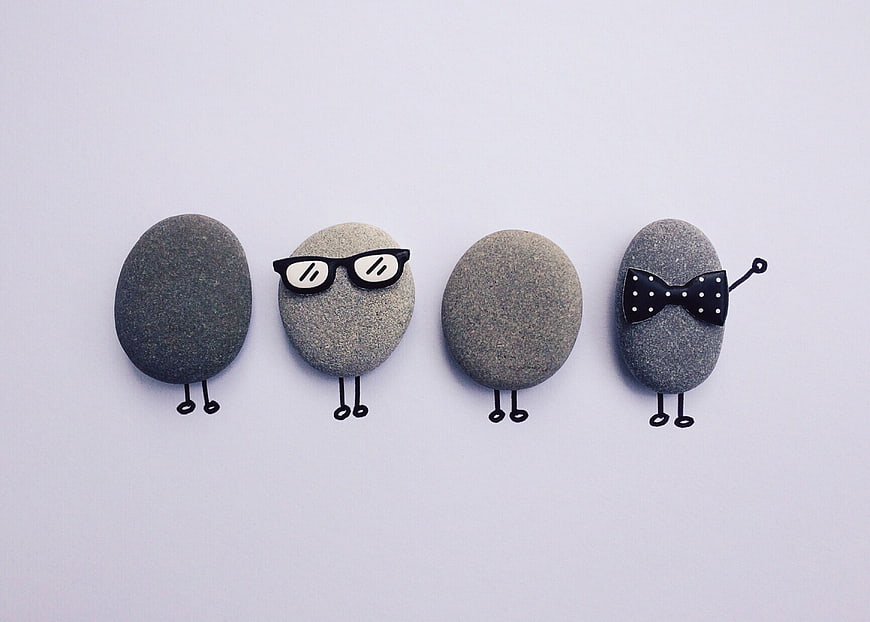 Cute Stone Characters with Glasses and Bow Tie on White Background