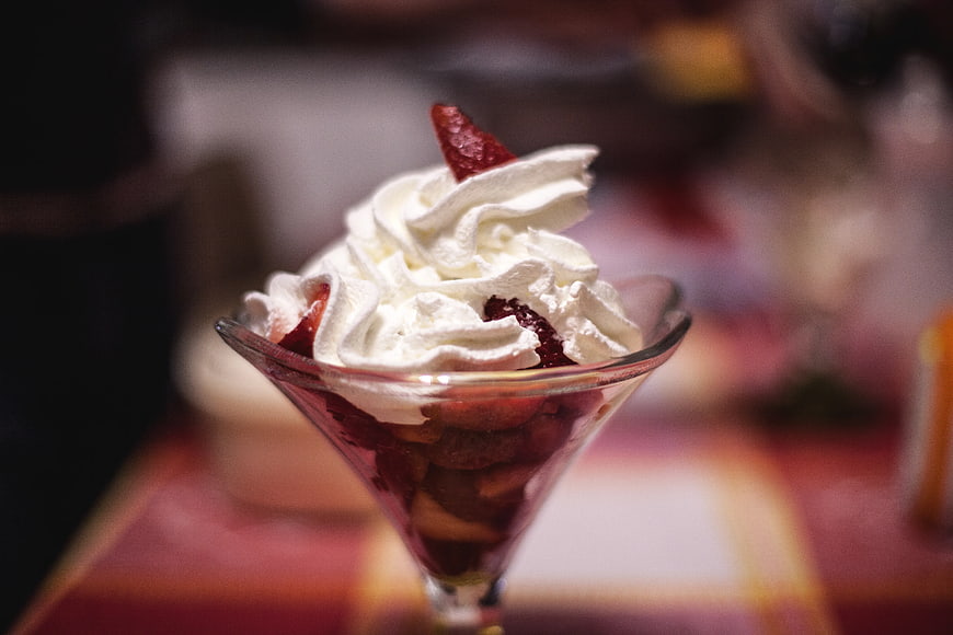 Strawberry dessert with whipped cream in a glass