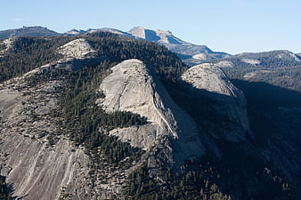Granite Mountain Peaks with Pine Forests and Blue Sky