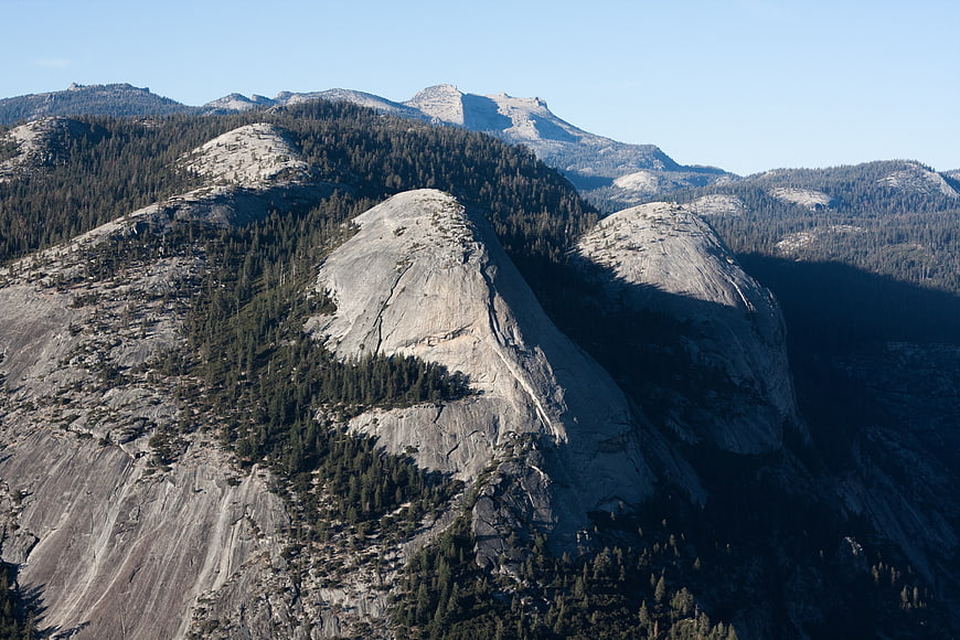 Granite Mountain Peaks with Pine Forests and Blue Sky