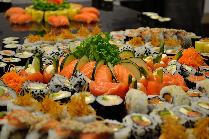 Colorful sushi platter with salmon, cucumber, and lettuce garnish