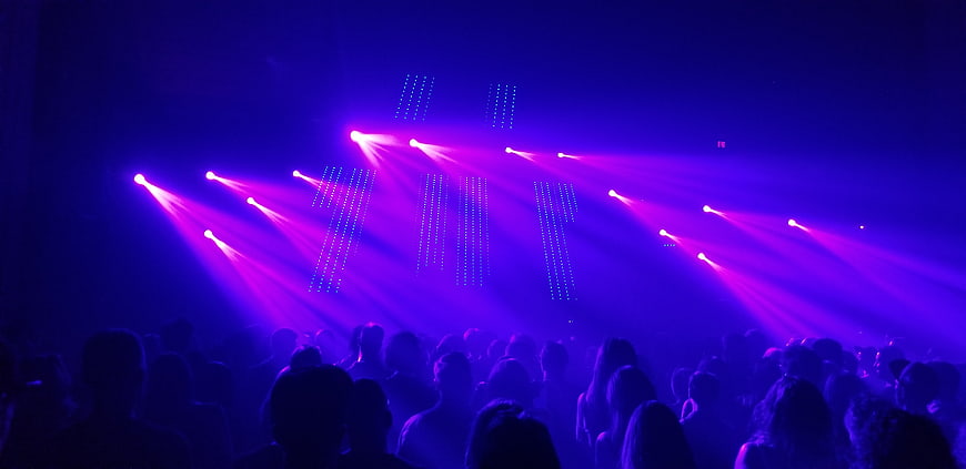 Vibrant Purple Stage Lights Over Silhouetted Concert Crowd