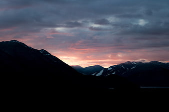 Dramatic Mountain Silhouette at Sunset with Pink Clouds
