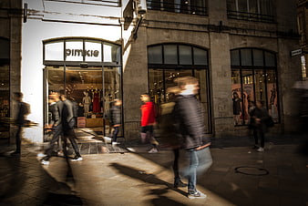 Motion blur pedestrians walking past Pimkie store