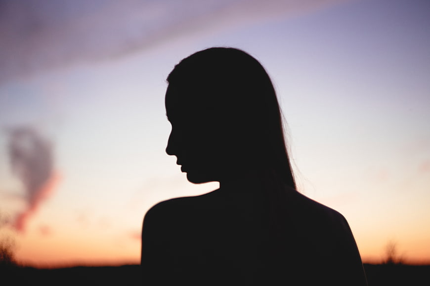 Silhouette of a Woman Against a Sunset Sky