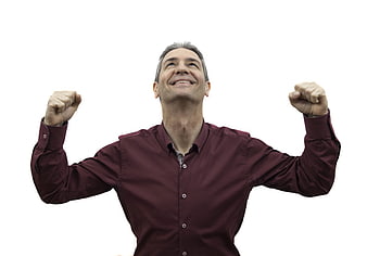Happy mature man celebrating success with raised fists
