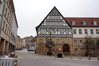 Historic Half-Timbered Building on Cobblestone Street in Eisenach, Germany