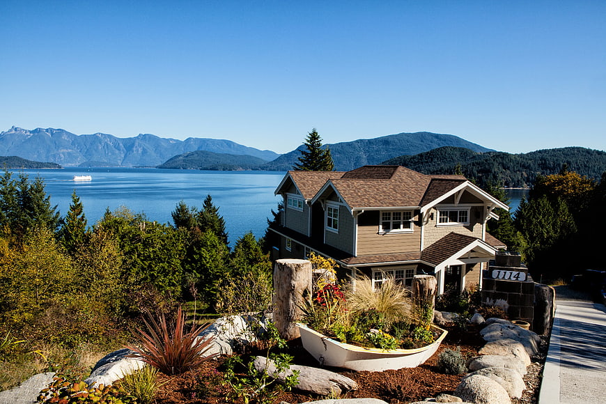 Modern coastal home with ocean and mountain views