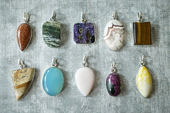 Collection of ten colorful gemstone pendants on silver settings