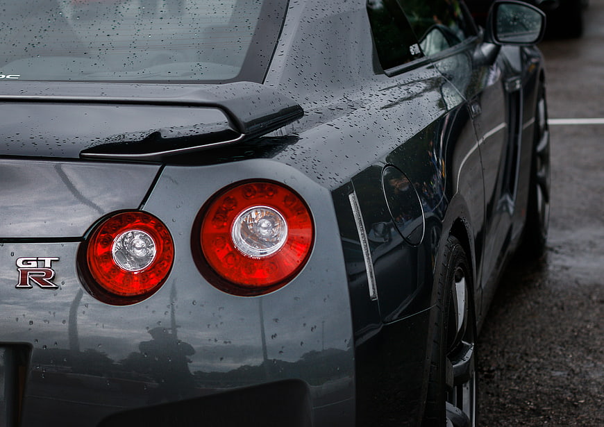 Close-up of Wet Black Nissan GT-R Rear Taillights