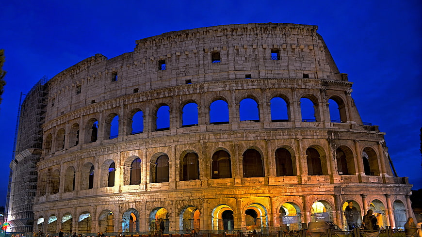 Colosseum in Rome at Night with Dramatic Blue Sky