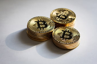 Stacks of Gold Bitcoin Coins on White Background