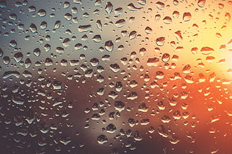 Raindrops on Glass with Warm Sunset Gradient Background