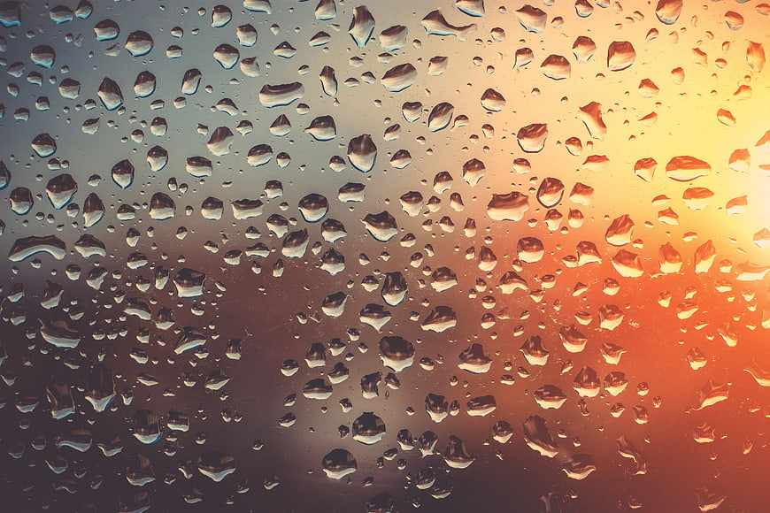 Raindrops on Glass with Warm Sunset Gradient Background