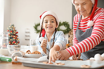 Grandmother and granddaughter baking Christmas cookies together
