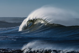 Powerful ocean wave crashing with white spray