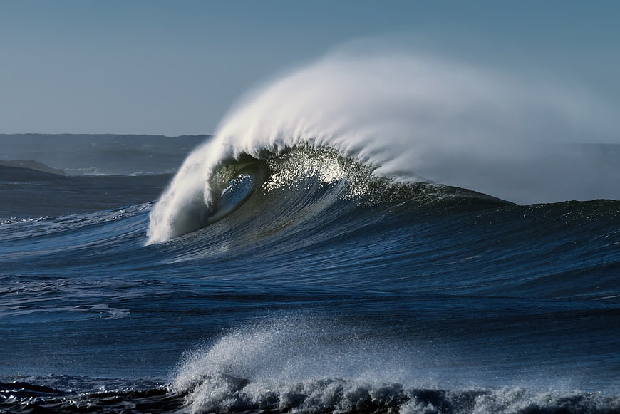 Powerful ocean wave crashing with white spray