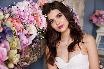 Beautiful Woman in White Dress with Colorful Floral Arrangement