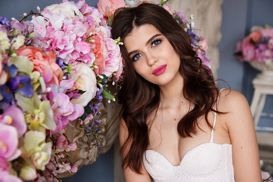 Beautiful Woman in White Dress with Colorful Floral Arrangement