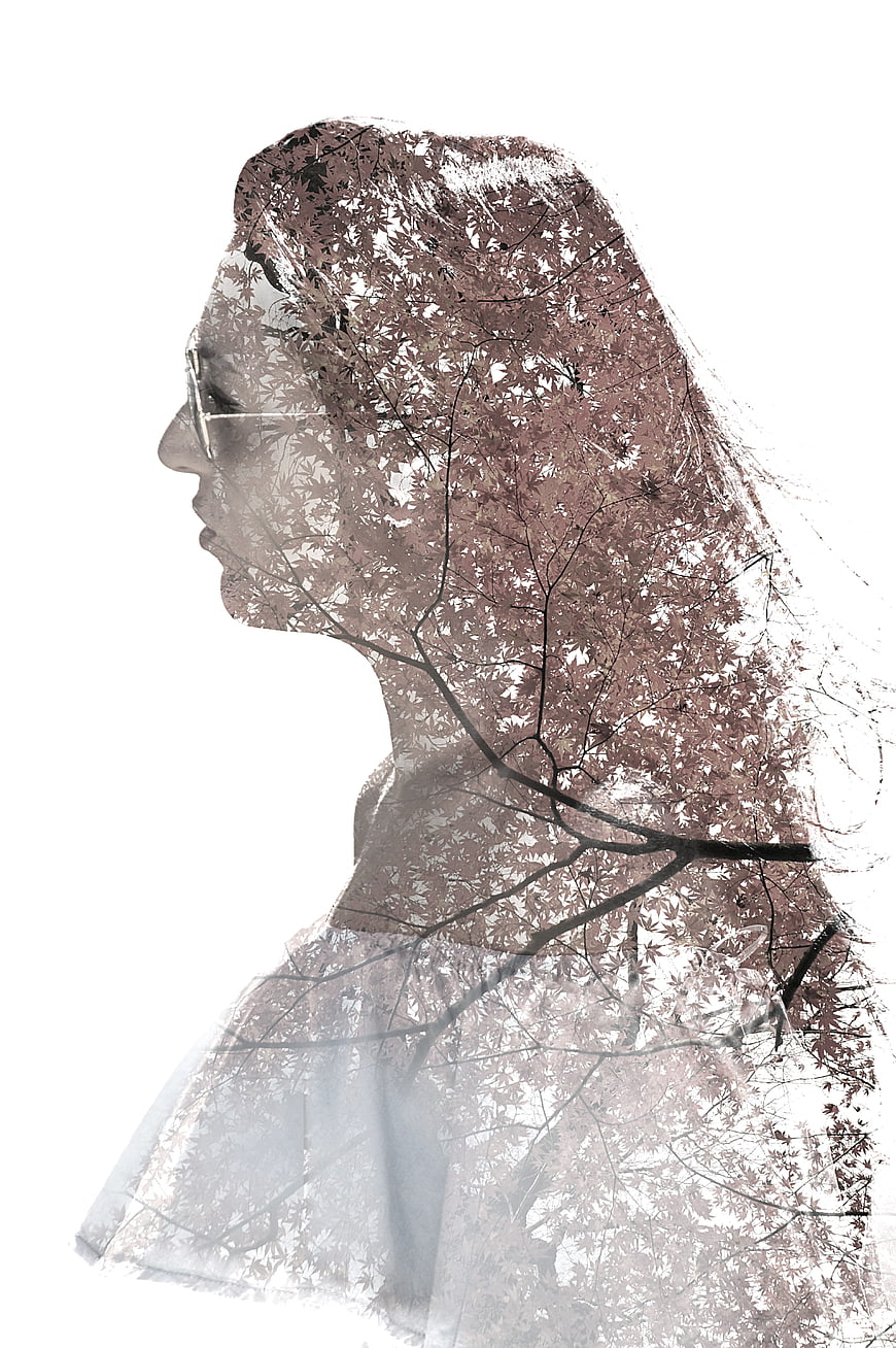 Artistic double exposure woman silhouette with autumn leaves